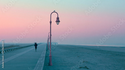 Solitary Figure on Misty Pier at Dawn