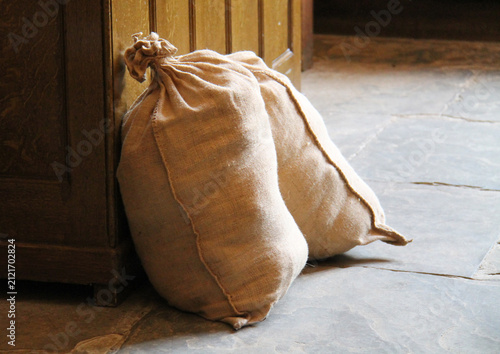 Two Hessian Sacks on an Old Flagstone Kitchen Floor.