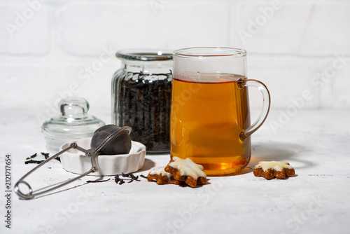 tea in a glass cup, gingerbread and brewing ingredients, closeup