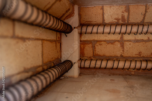Konstfotografi Empty inner heating chamber of electric muffle furnace with refractory firebricks and spiral heating elements inside ceramic workshop kiln