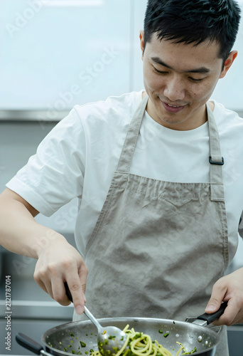 Smiling asian man in a whit...
