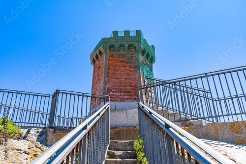 Obraz na plátně Old brick tower in rio marina elba island with safety netting on top and metal r