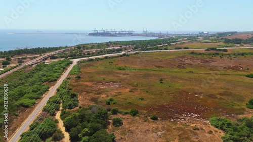 coastline near the Port of Sines and green landscape. Sines, Setubal, Portugal. Aerial view. Moving forward 