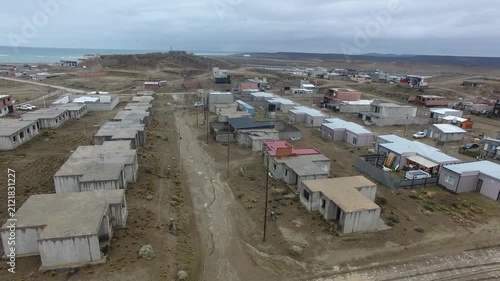 Cinematic 4K drone aerial of new residential neighborhoods in Caleta Olivia, Santa Cruz, Patagonia, Argentina. Showcasing urban growth, modern housing, city planning, infrastructure, and suburban deve