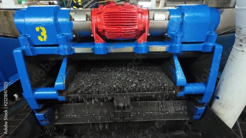 A shale shaker on an oil rig is a vibrating screen that separates large drilled solids, or cuttings, from the drilling fluid, or mud.