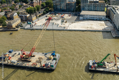 Canvas Print Cranes on Barges Float on the Thames Near a London Building Site