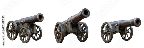 Antique cannons stand ready for action on a stark black background