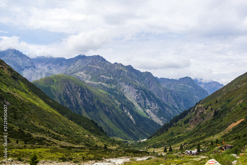 Fototapeta premium Mountain valley with alpine huts and hiking trail, Austria, Tyrol, Zams, 29 June 2026