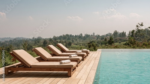 Relaxing lounge chairs by infinity pool overlook lush green landscape