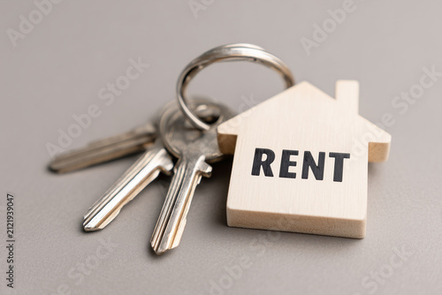 House Keys with Wooden Home Shaped Keychain and Rent Text Word