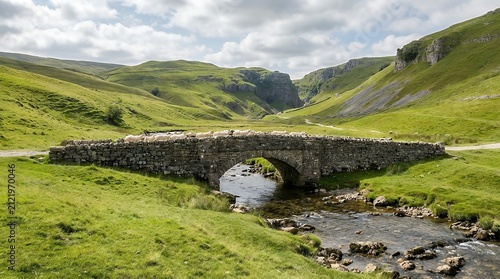 A serene and picturesque scene of sheep crossing a stone bridge over Gordale Beck near Malham Cove in the beautiful Yorkshire Dales National Park perfect for holidays and nature lovers. gordale beck