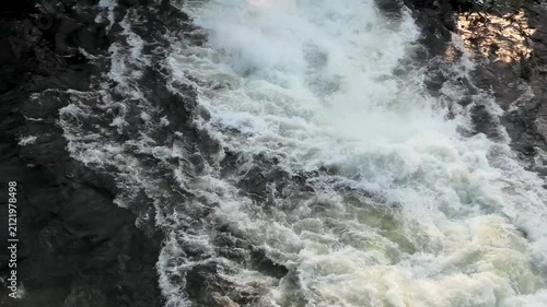 Water gushing out through the shutter of a gravity dam