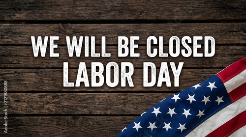 We will be closed labor day sign with american flag on rustic wooden background