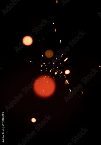 Abstract Bokeh Lights and Sparks on Dark Background.