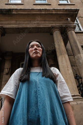 Photography Young woman looking up with determination in urban setting