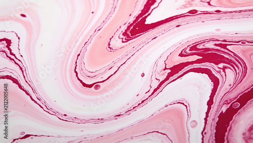 Fluid art marbling background featuring smooth, flowing waves of soft blush pink, stark white, and delicate deep magenta veins