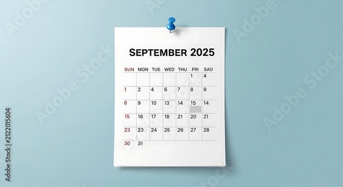 A simple September 2025 calendar hangs on a light blue wall
