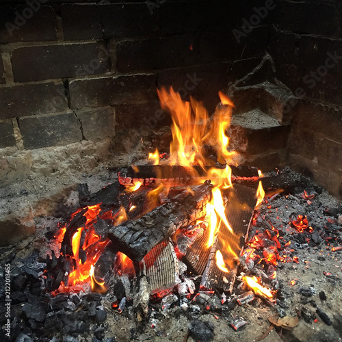 An open fire burning in a picnic shelter