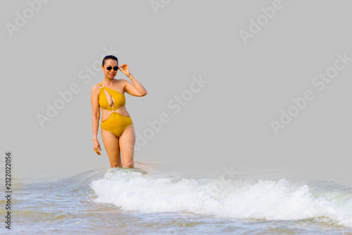 Woman in yellow swimsuit isolated