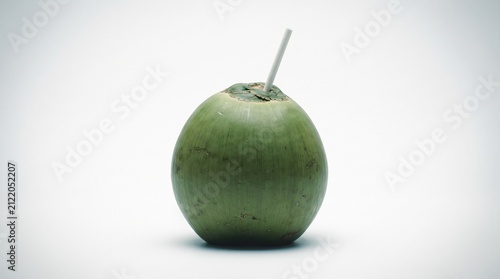 Coconut stands upright with a straw inserted into the top, presenting a tropical refreshment isolated on a seamless white surface for clear product presentation.