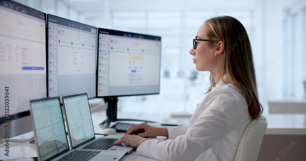 © Andrey Popov - Young Woman Reviewing Patient Medical Claims On Laptop