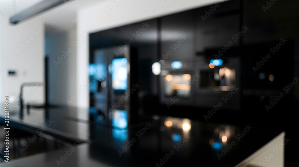 Fototapeta premium Modern black kitchen interior with blurred background, luxury dark minimalist kitchen design, sleek contemporary home appliances and cabinets