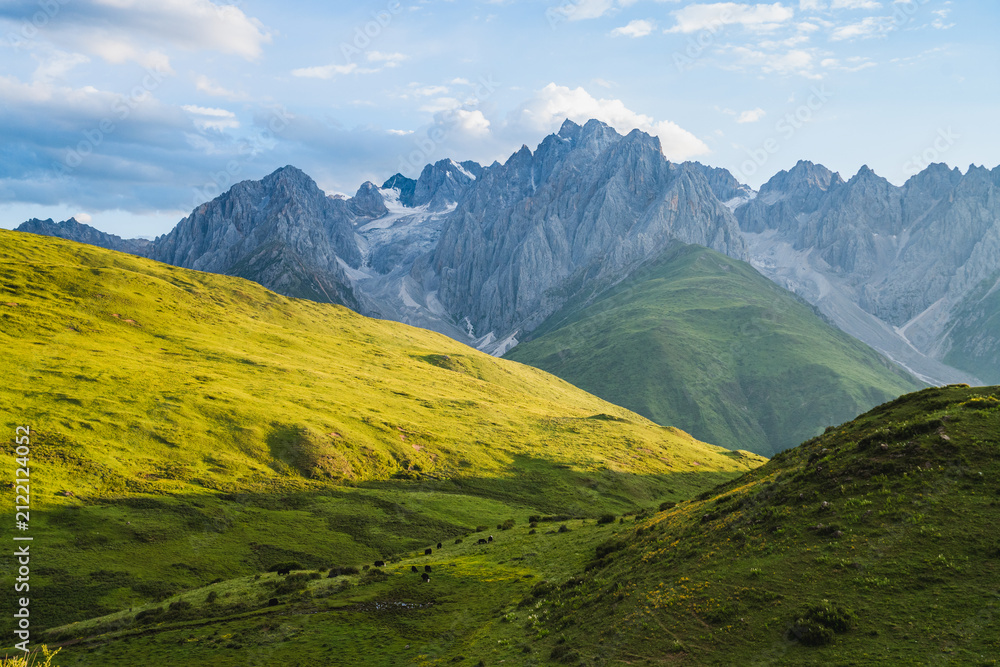 Fototapeta premium High altitude grassland and jagged mountain scenery, Sichuan, China