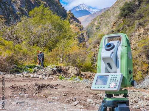 Surveying Instrument in Rugged Mountain Valley