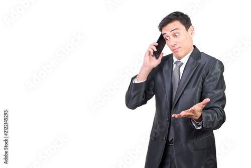 Foto Confused man in suit talking on smartphone