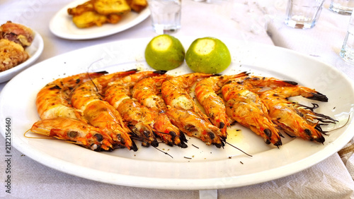 Photography shrimps grilled on the plate with lemon from greece