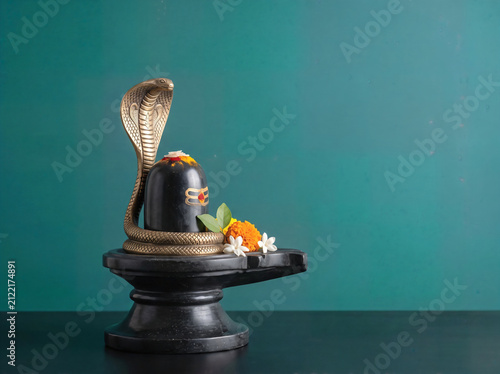 Lord Shiva Mahadeva Symbol Shivlinga with cobra snake, traditional Hindu puja Naag Panchami, spiritual Mahashivratri worship concept Background. 