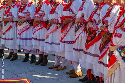 Fotografía Close-up of women standing arm in arm in authentic Croatian folk costumes with e