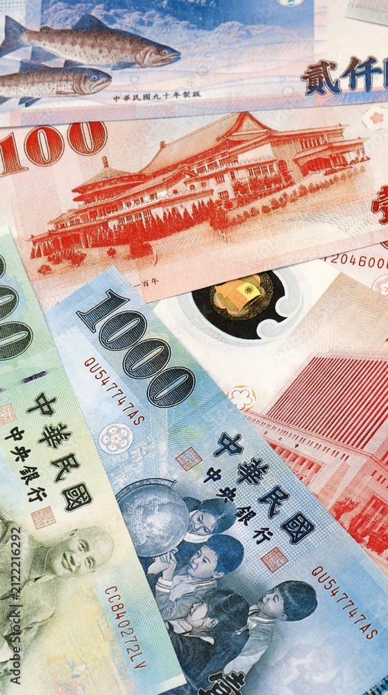 Fototapeta premium New Taiwan dollar money bills in pile on table. Taiwan TWD currency cash close up