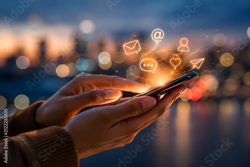 Hands Holding Smartphone With Communication Icons