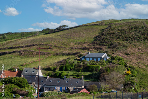 Rural village with stone cottages on sloped terrain