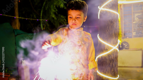 Happy Indian Child Enjoying Sparkler Fireworks During Traditional Diwali Night Celebration