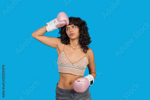 Young woman feeling exhausted after intense boxing workout