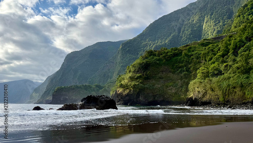 Seixal black sand beach with lush green cliffs, Madeira island, Portugal