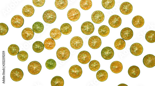 Close-up view of numerous small, round, green and orange citrus fruit slices scattered on a white background.