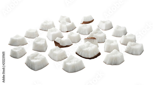Freshly cut white coconut pieces scattered on a clean white background, showcasing their texture and natural appearance.