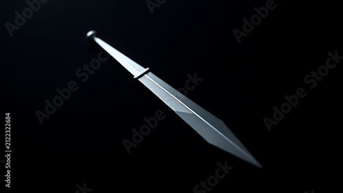 Polished steel dagger on black velvet, edge catching a sharp beam of light.