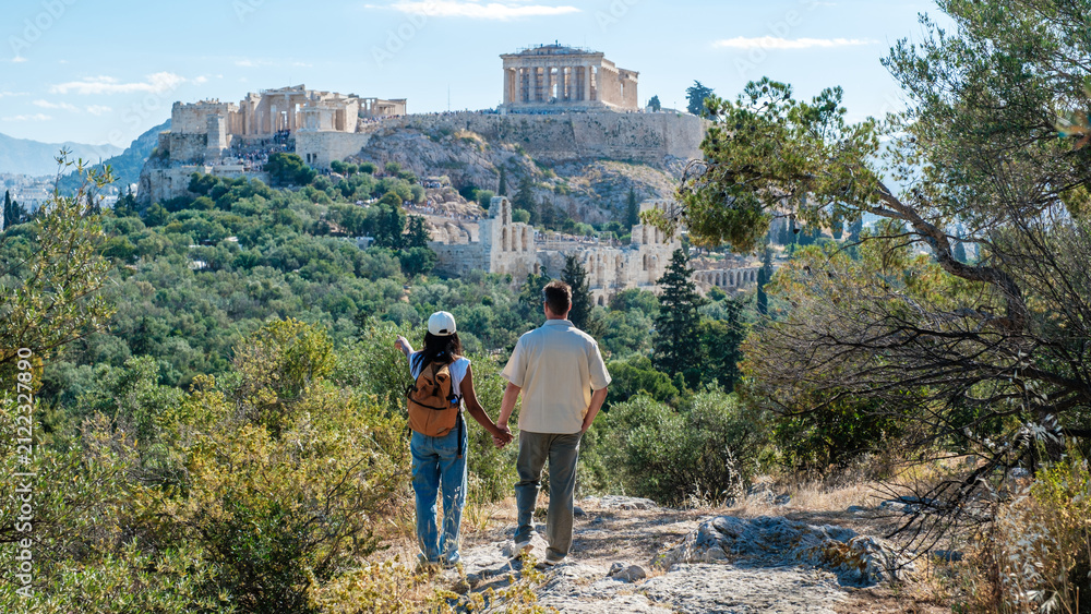 Fototapeta premium Strolling hand in hand towards the Acropolis in Athens, Greece on a sunny day