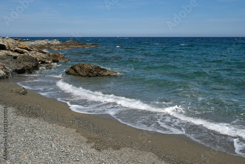 Mediterranean seascape in Southern France with rocks, beach and waves