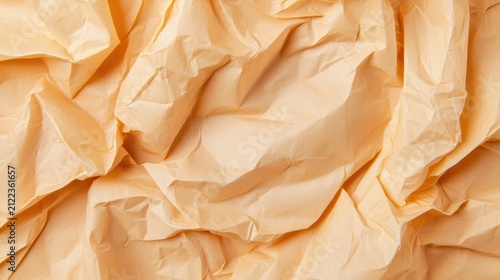 Close-up of crumpled, textured beige paper with shadows highlighting its uneven surface.