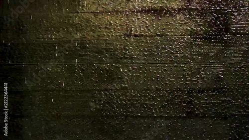 Illuminated fountain wall with flowing water texture design Thailand.