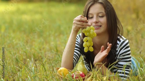 Young beautiful woman eat ripe grapes