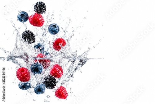 Fresh Mixed Berries Splashing into Clear Water with Copy Space on White Background