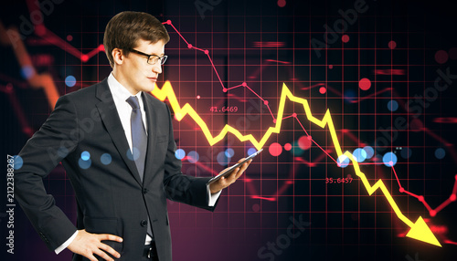 Businessman Analyzing Falling Stock Market Trends on a Dark Financial Chart B...