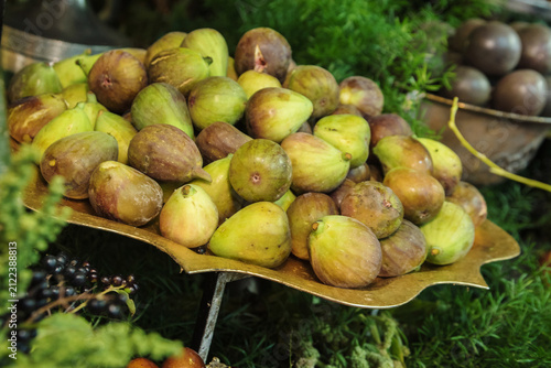 Fresh ripe figs on a golden platter at a holiday buffet