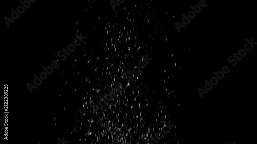 White dust particles falling on black background